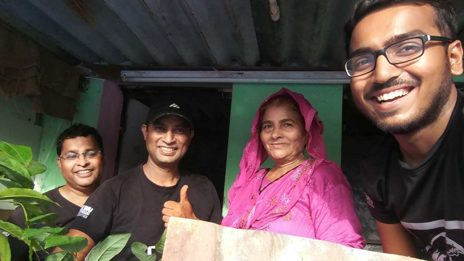 Earth5R volunteers and slum women tending sapling nurseries on rooftops in Mumbai — urban greening from the ground up