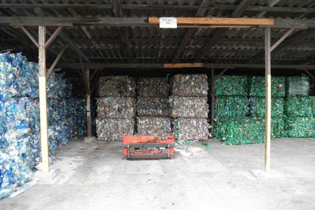 Stacks of compressed plastic bottles stored in a recycling facility, highlighting Earth5R’s circular economy approach that promotes Waste Management, Sustainability, and ESG-led CSR initiatives as a Mumbai-based NGO transforming waste into valuable resources and local green jobs.