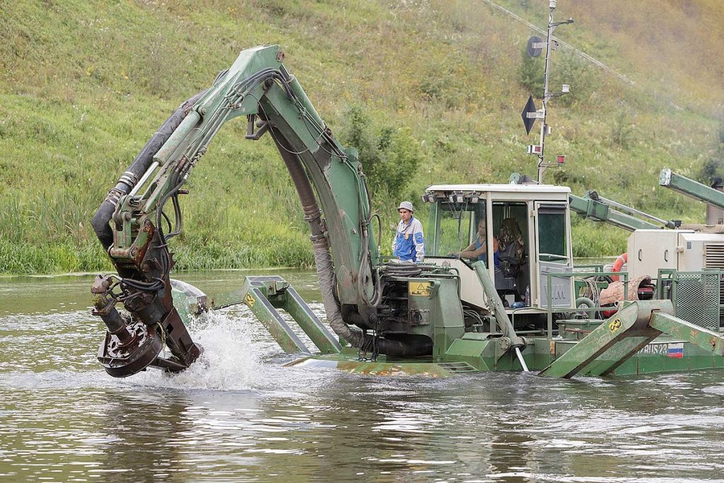 River-cleaning dredger machine removing waste from water as part of sustainability, ESG, and CSR-driven river restoration and waste management projects supported by environmental NGO Earth5R in India.