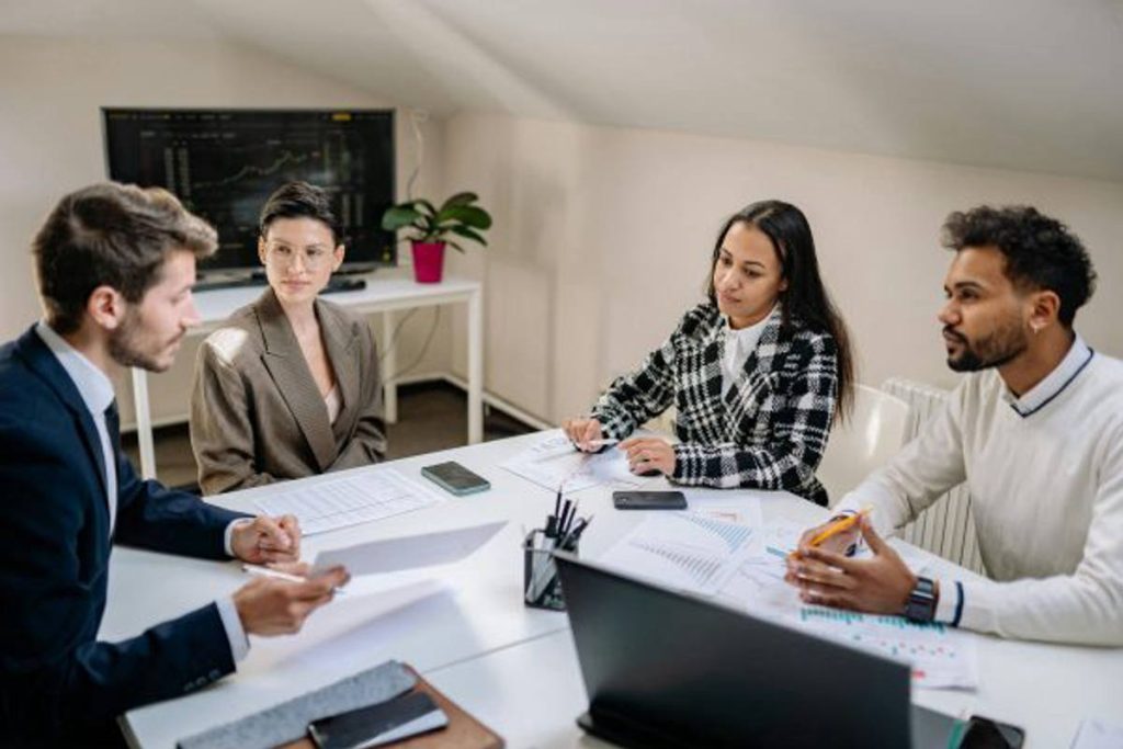A team of sustainability professionals in a meeting discussing ESG policies and green finance models, representing Earth5R’s commitment to promoting responsible investing, Waste Management, and Sustainability through ESG- and CSR-driven initiatives as a leading NGO in Mumbai.
