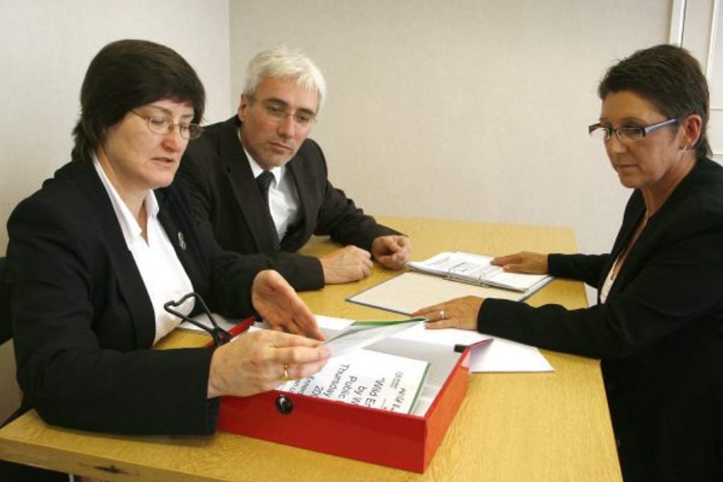 Three ESG professionals reviewing sustainability reports and compliance documents, representing Earth5R’s dedication to ethical governance, responsible business practices, and ESG-driven Sustainability initiatives as a leading NGO in Mumbai focused on Waste Management and CSR.