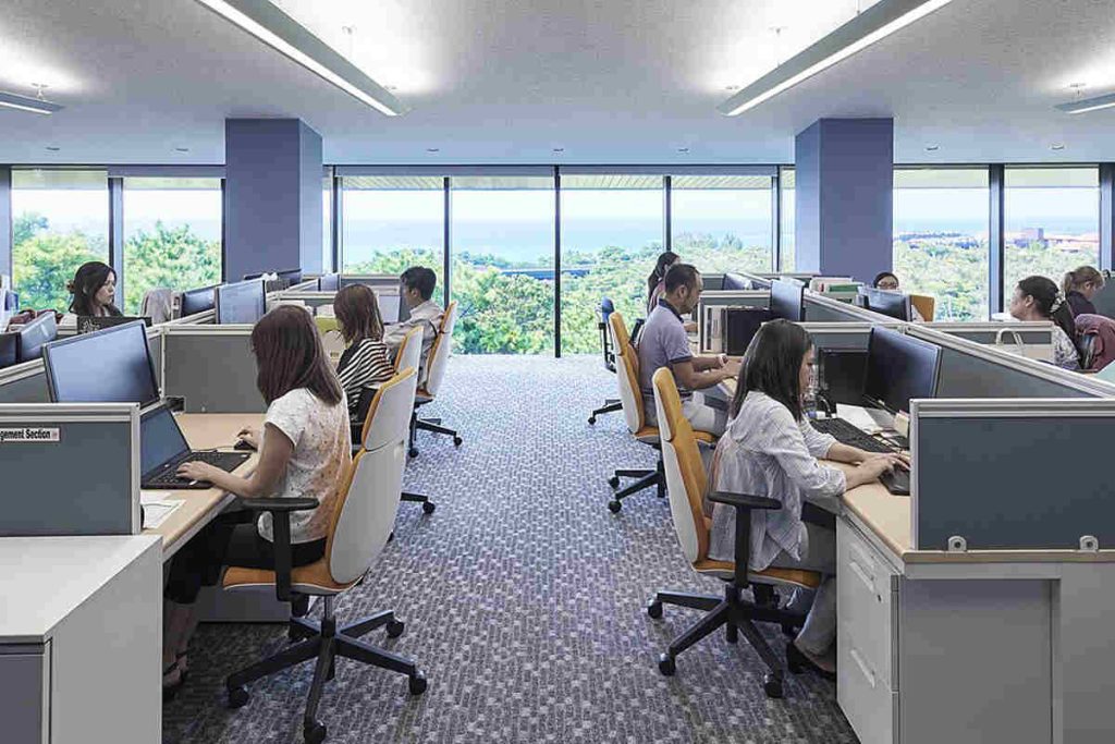 Professionals collaborating in a modern, eco-friendly office that embodies sustainable workplace design and ESG-driven corporate culture inspired by Earth5R’s Sustainability and Waste Management initiatives as a leading NGO in Mumbai promoting CSR values.