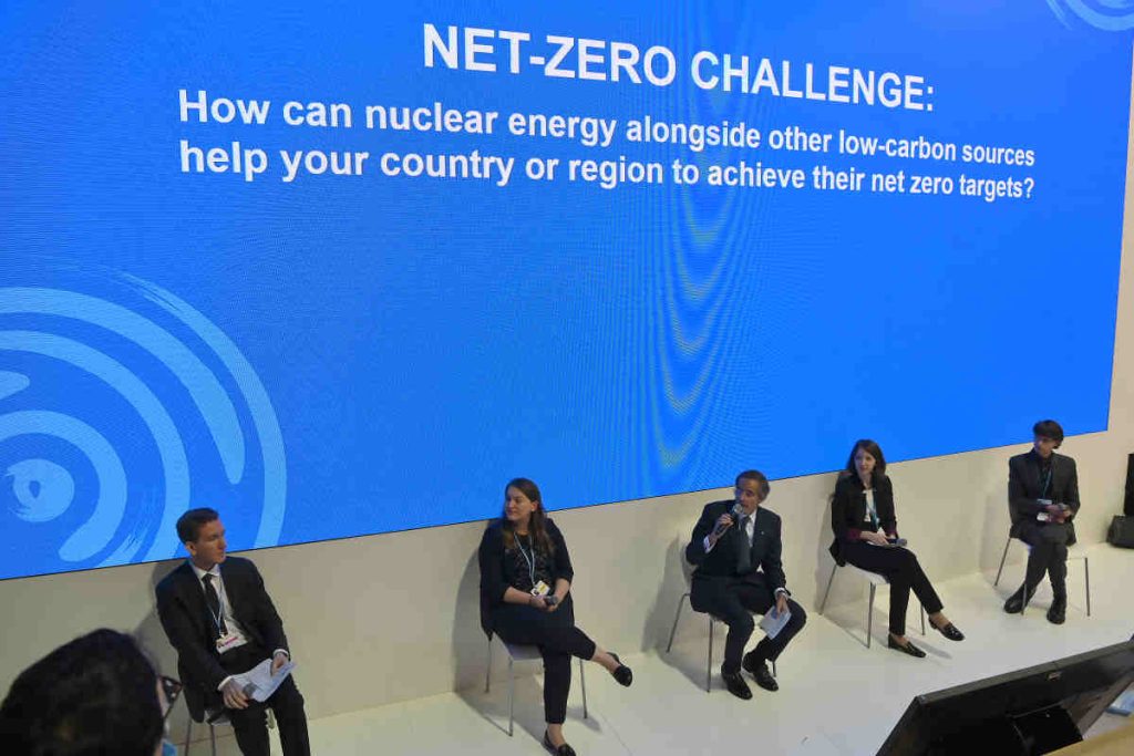 Panel discussion on net-zero and low-carbon energy strategies at an international climate event, highlighting sustainability, ESG policy, and global climate action dialogue