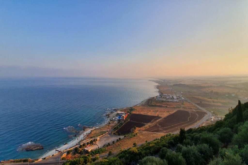 A coastal landscape with farmland and ocean shoreline, used in a feature on Earth5R’s sustainability, CSR, ESG, and waste management initiatives led by the Mumbai-based environmental NGO.