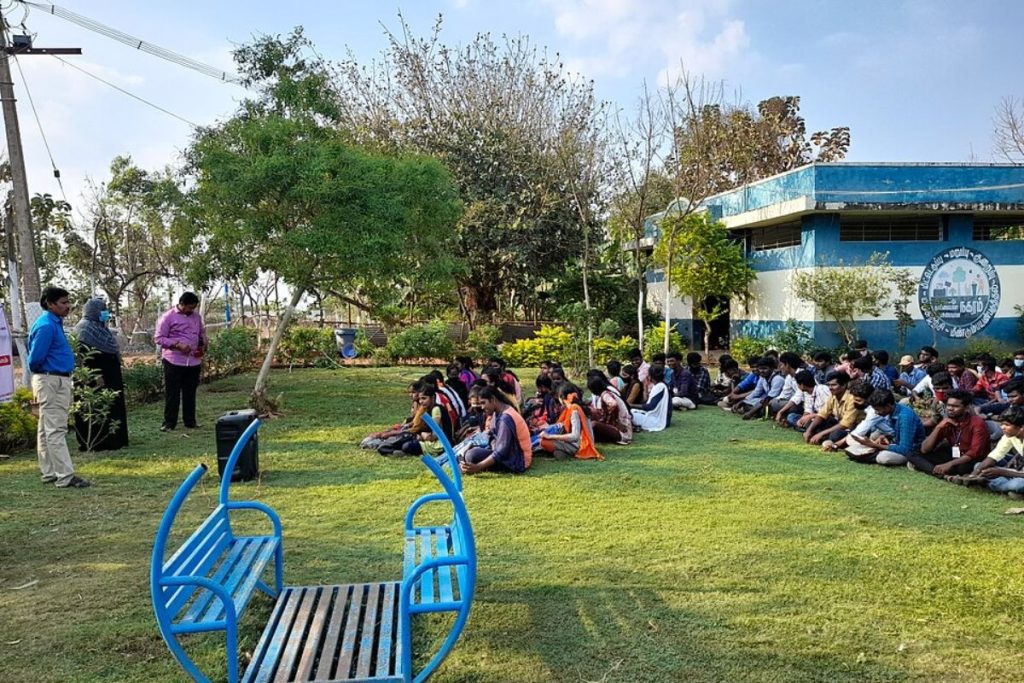 Community waste management training session by Earth5R NGO in an open green space.