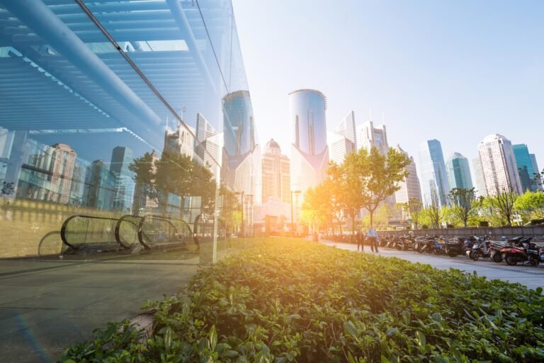 Glass office towers and green landscaping at sunrise