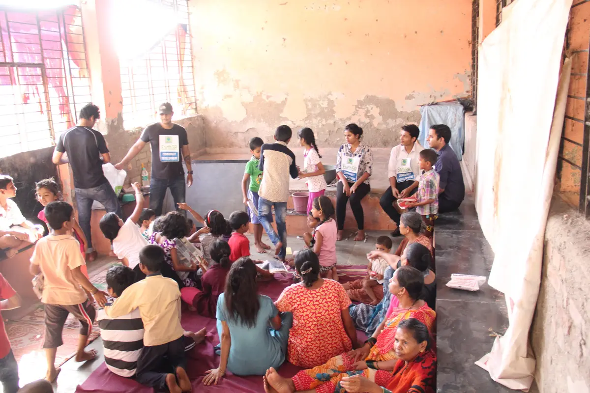 Children and volunteers sitting together at an upcycling workshop, Earth5R CSR programme