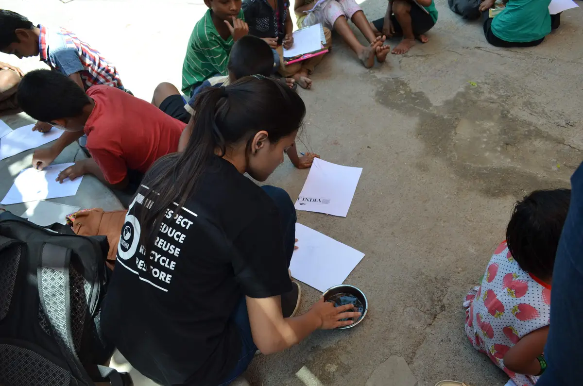 Children drawing on sheets on the ground during an Earth5R environmental activity, Earth5R CSR programme