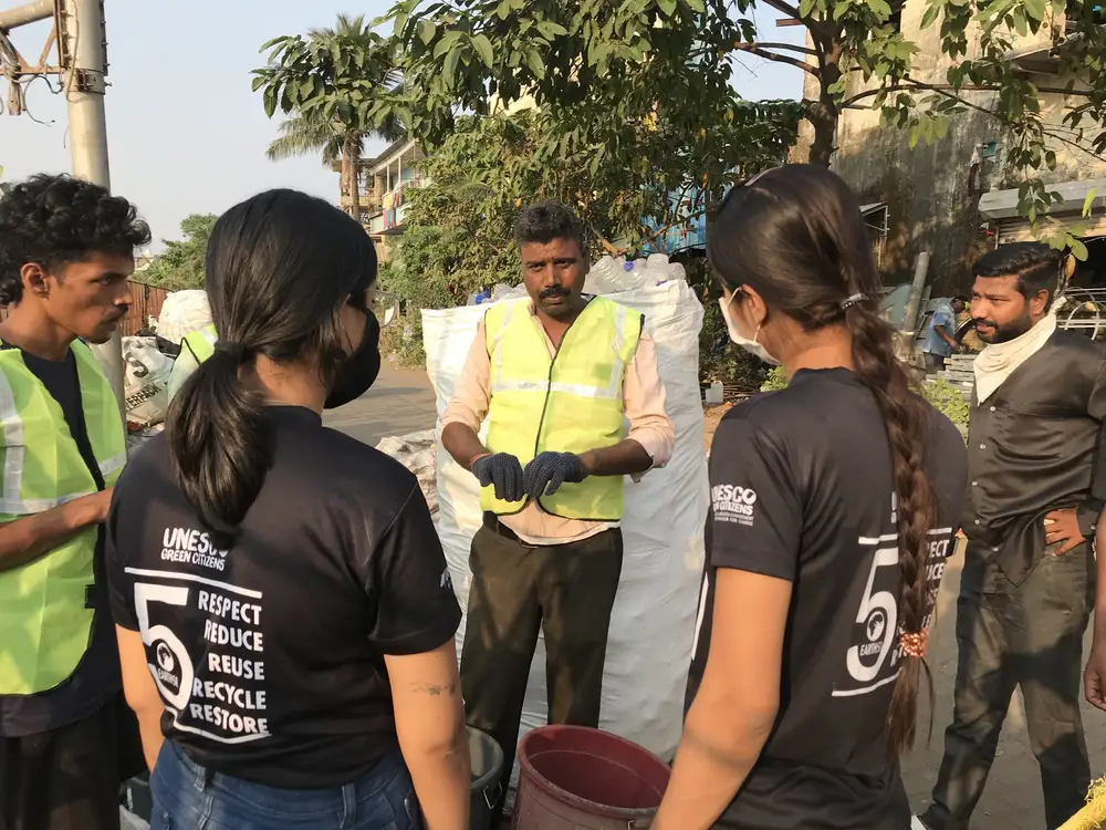Earth5R team explaining plastic grades to local waste collectors in the Mithi River catchment in Mumbai