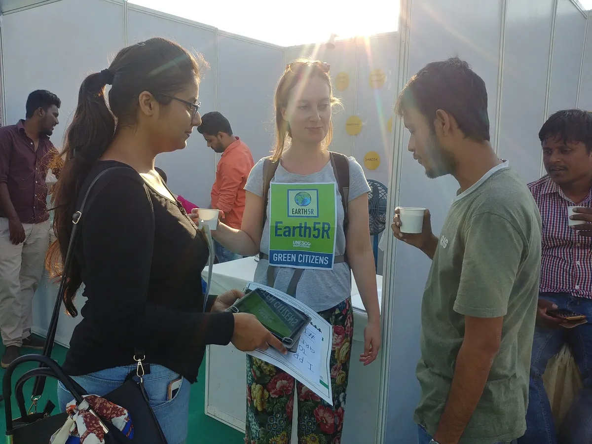 Earth5R volunteer training visitors on recycling and responsible consumption at a public event stall