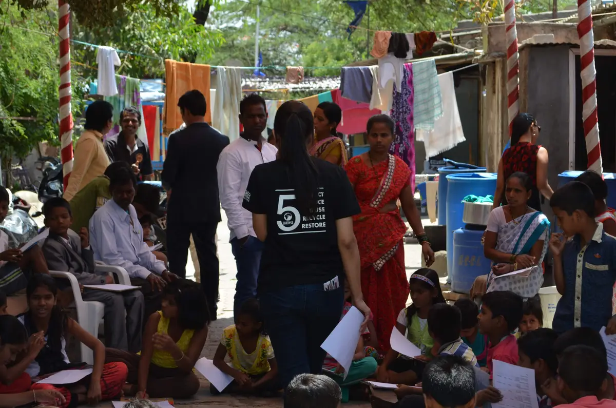 Sonam Sengar, Earth5R volunteer team leader, addressing residents and children in a community settlement