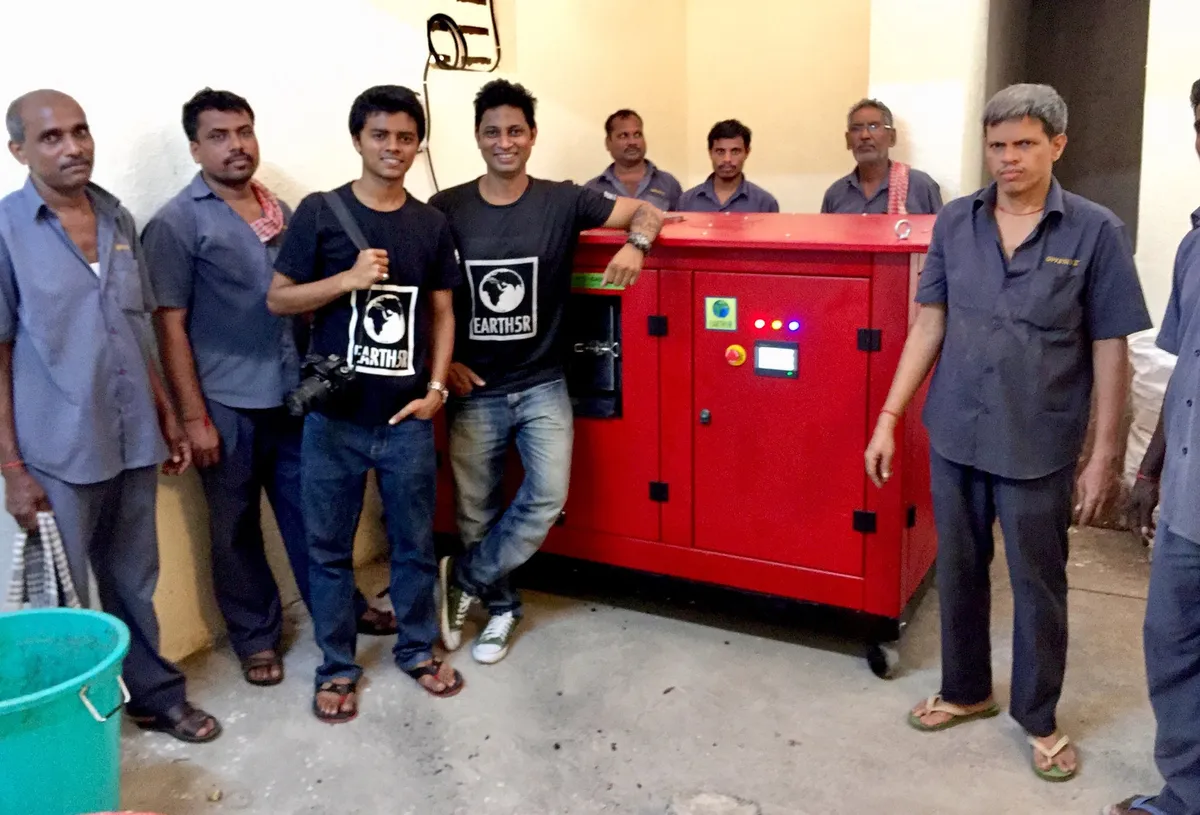 Saurabh Gupta and Earth5R team members with building staff beside a red organic waste composting machine installed in a residential building in Mumbai