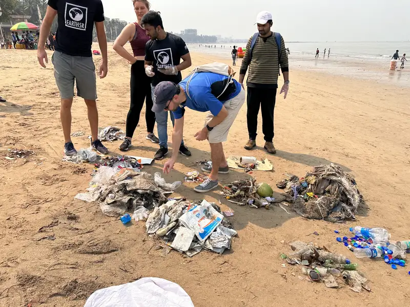 Lufthansa employee volunteers and the Earth5R team segregating waste during a Juhu beach cleanup in Mumbai