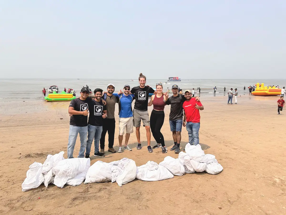 Lufthansa employee volunteers and the Earth5R team with bags of waste collected at Juhu beach in Mumbai