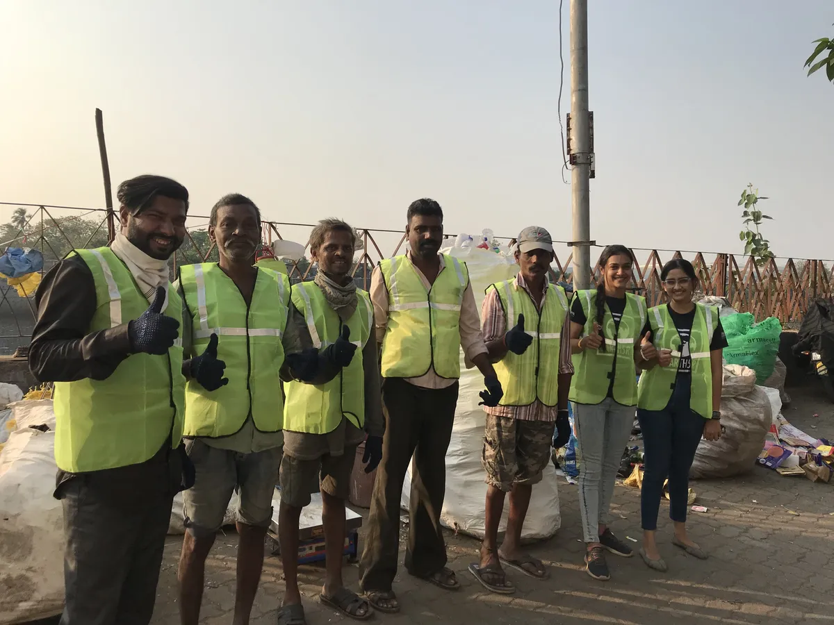 Earth5R team with local waste collectors in safety vests after plastic recovery training at the Mithi River in Mumbai