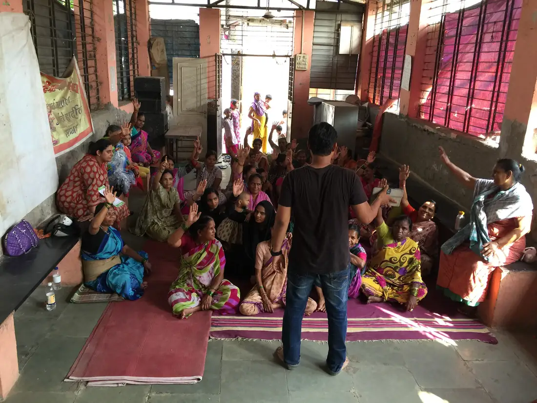 Earth5R facilitator leading an interactive session with women in a community hall in Mumbai
