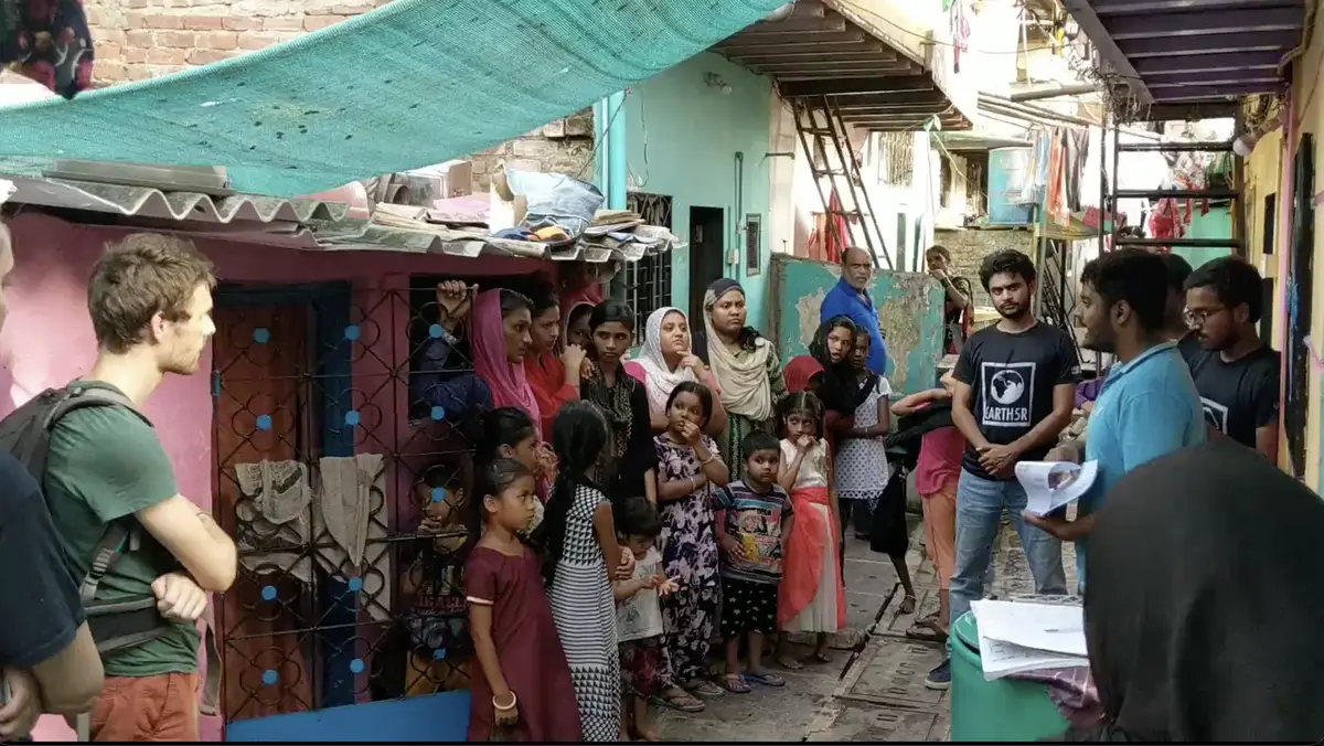 Earth5R volunteers training settlement residents on saving, bank accounts and the rooftop plantation programme in Mumbai