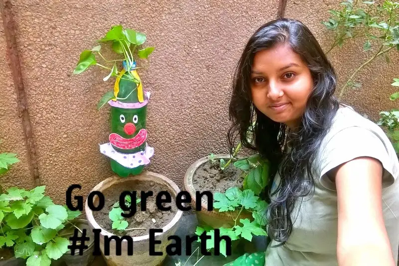 Selfie with an upcycled bottle planter and the words Go green #ImEarth, Earth5R CSR programme