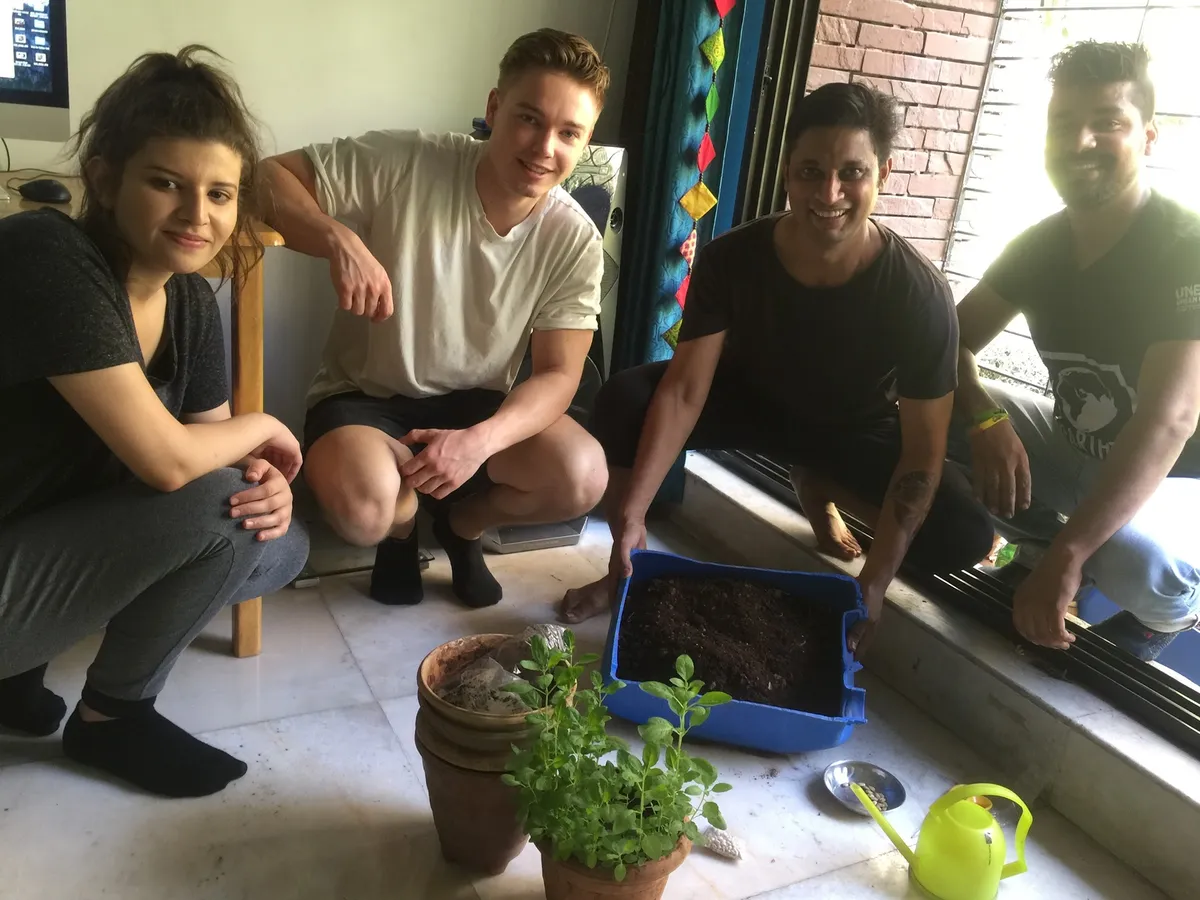 High school nutrition internship field work. Earth5R volunteers with home compost and potted plants grown using it