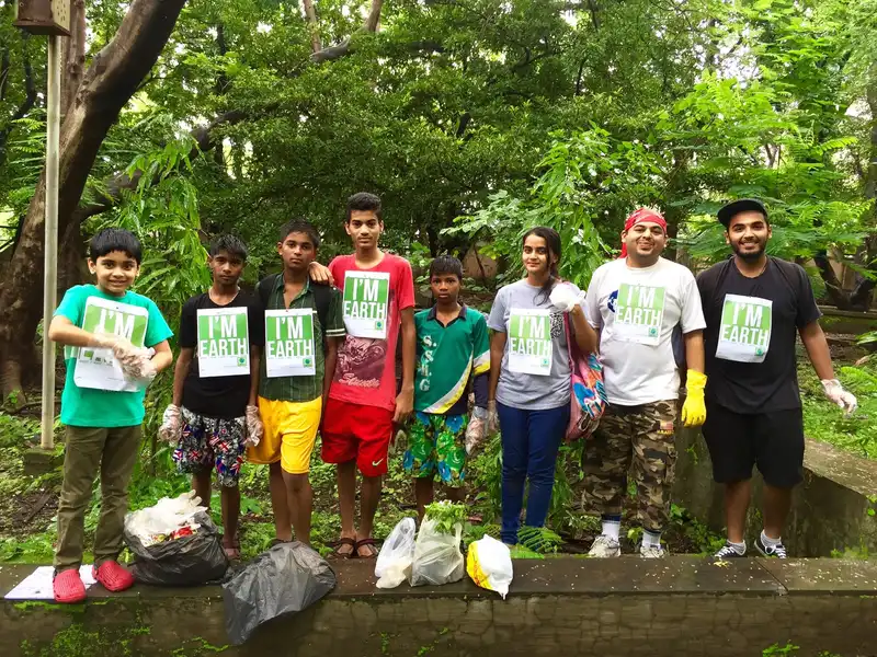 Earth5R CSR NGO cleanup drive: volunteers with I'm Earth badges and bags of collected waste in Mumbai