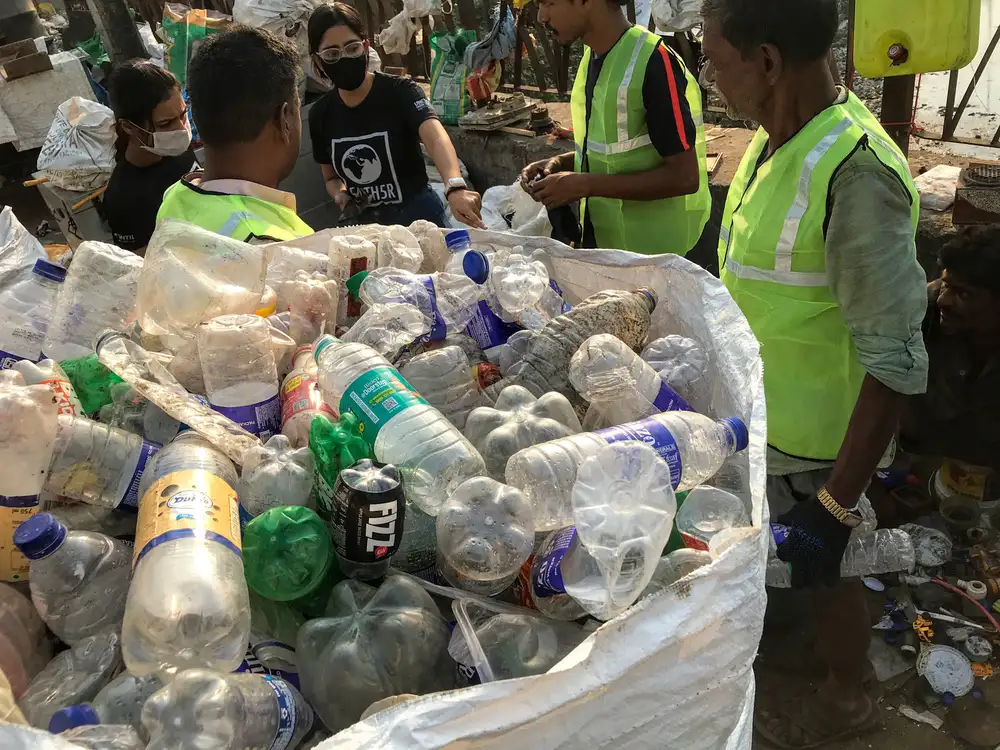 Waste collectors and Earth5R team with a bulk bag of recovered PET bottles for recycling in Mumbai
