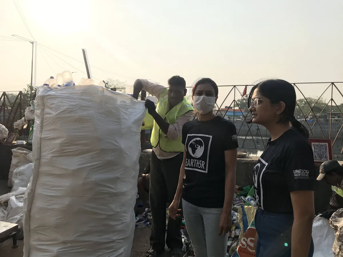 Earth5R team with waste collectors and bags of recovered plastic on the Mithi River bank, Mumbai