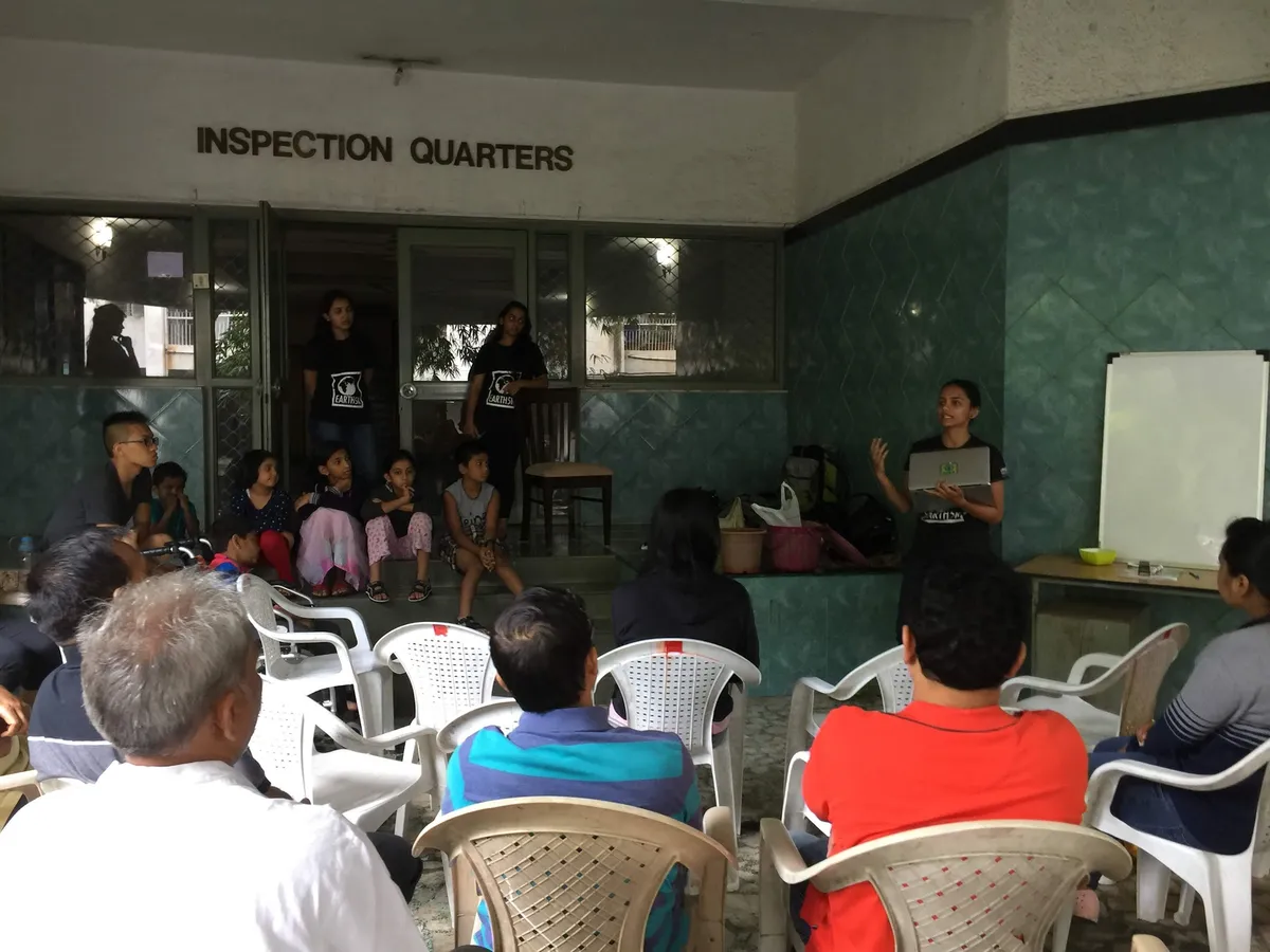 Earth5R volunteer leading a waste management training for residents and children