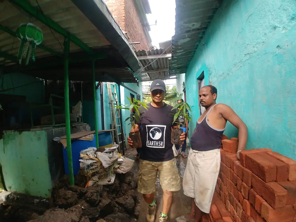Earth5R team delivering saplings for rooftop planting to a family in a Mumbai informal settlement
