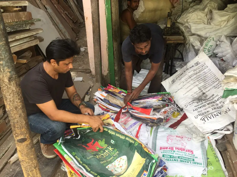 Saurabh Gupta of Earth5R sorting recovered plastic with a stitching shop that makes waste collection sacks