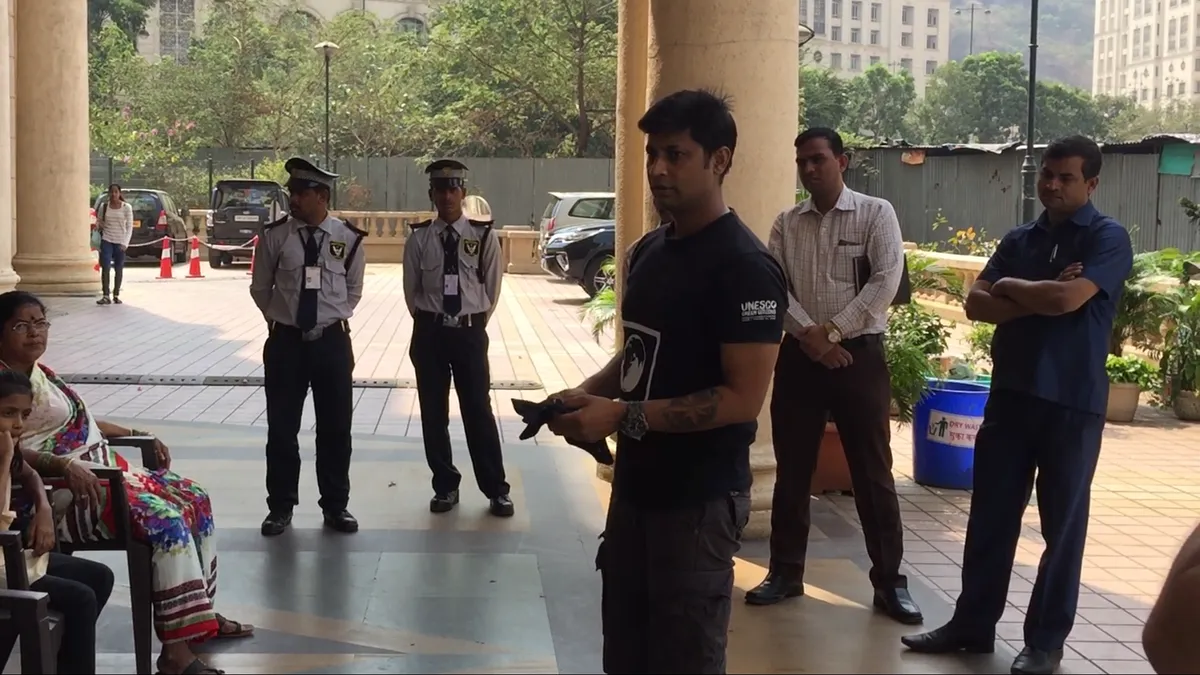 Saurabh Gupta training security and housekeeping staff on waste segregation in a building lobby, Earth5R CSR programme