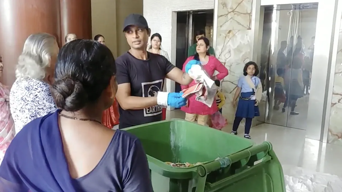 Saurabh Gupta showing residents the wrongly segregated waste from their building bin, Earth5R CSR programme