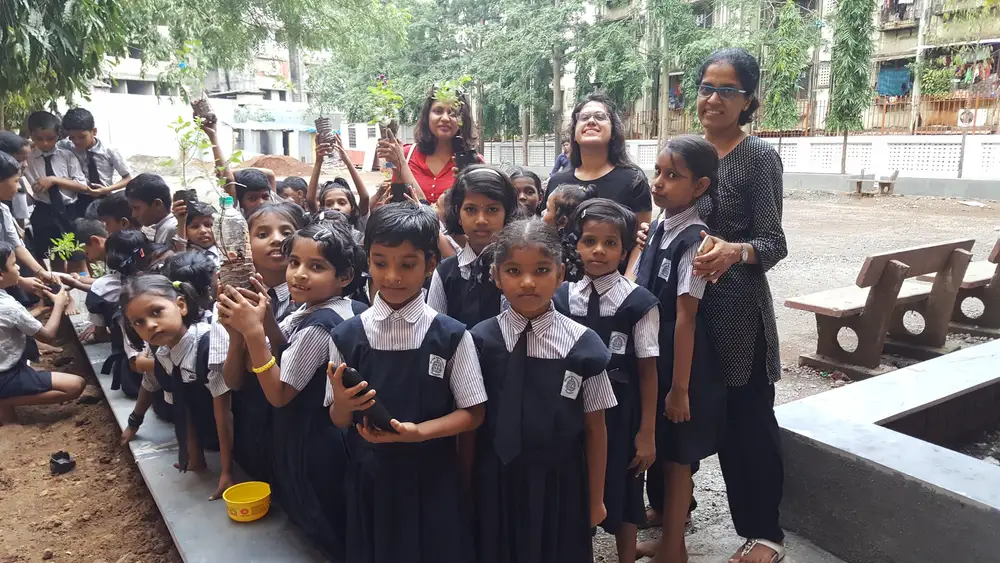 School children planting saplings in their school ground with Earth5R volunteers