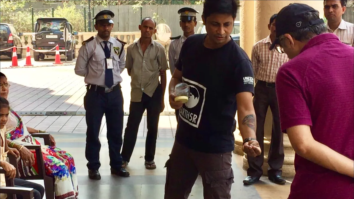 Saurabh Gupta showing security guards and staff how to segregate waste correctly, Earth5R CSR programme in Mumbai