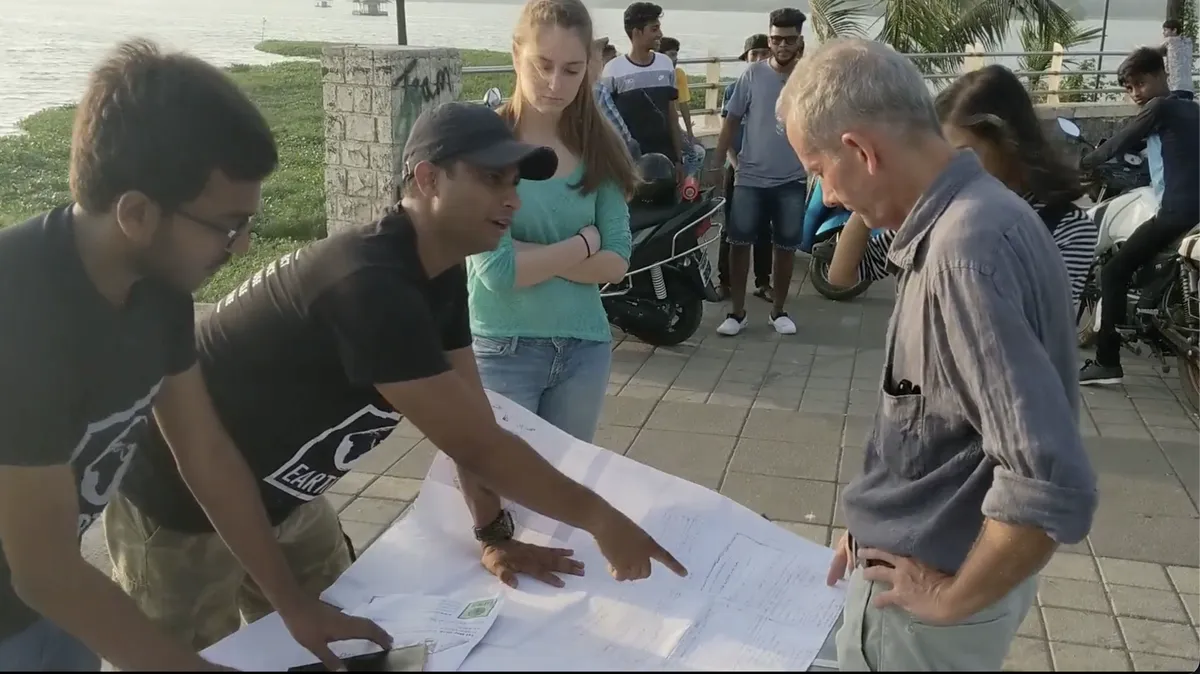 Urban planning internship field work. Earth5R team planning local sustainability solutions on a chart with citizens and experts
