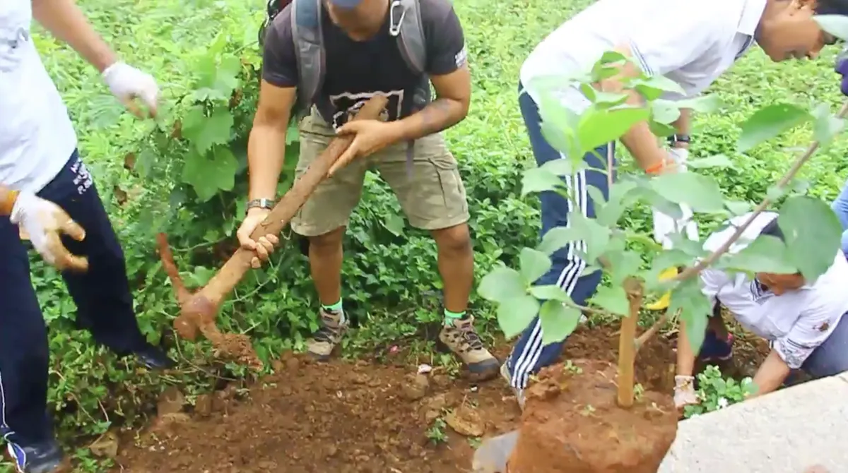 Earth5R volunteers digging pits to plant saplings during a plantation drive