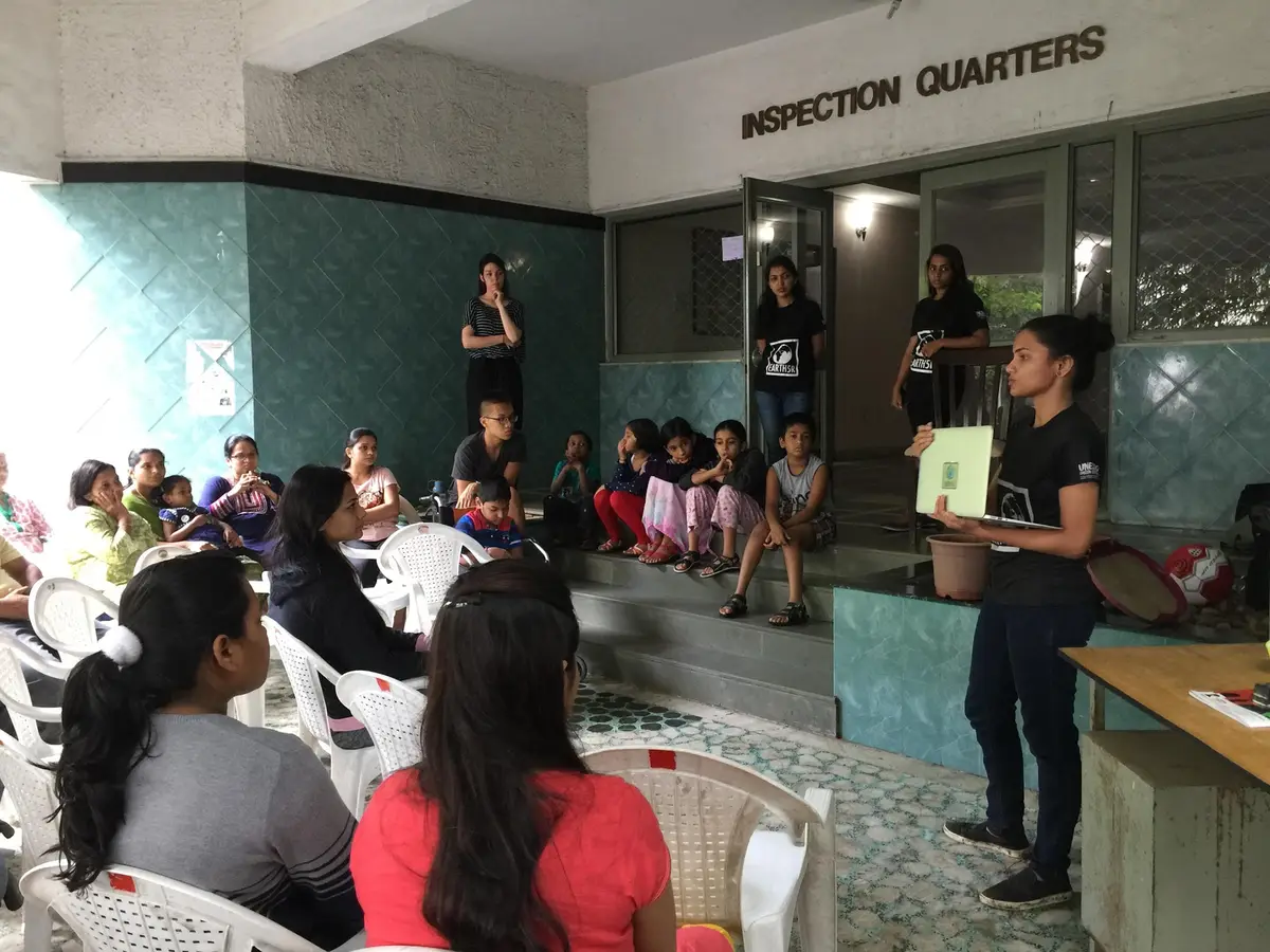 Earth5R volunteer presenting circular economy basics to residents in a community hall