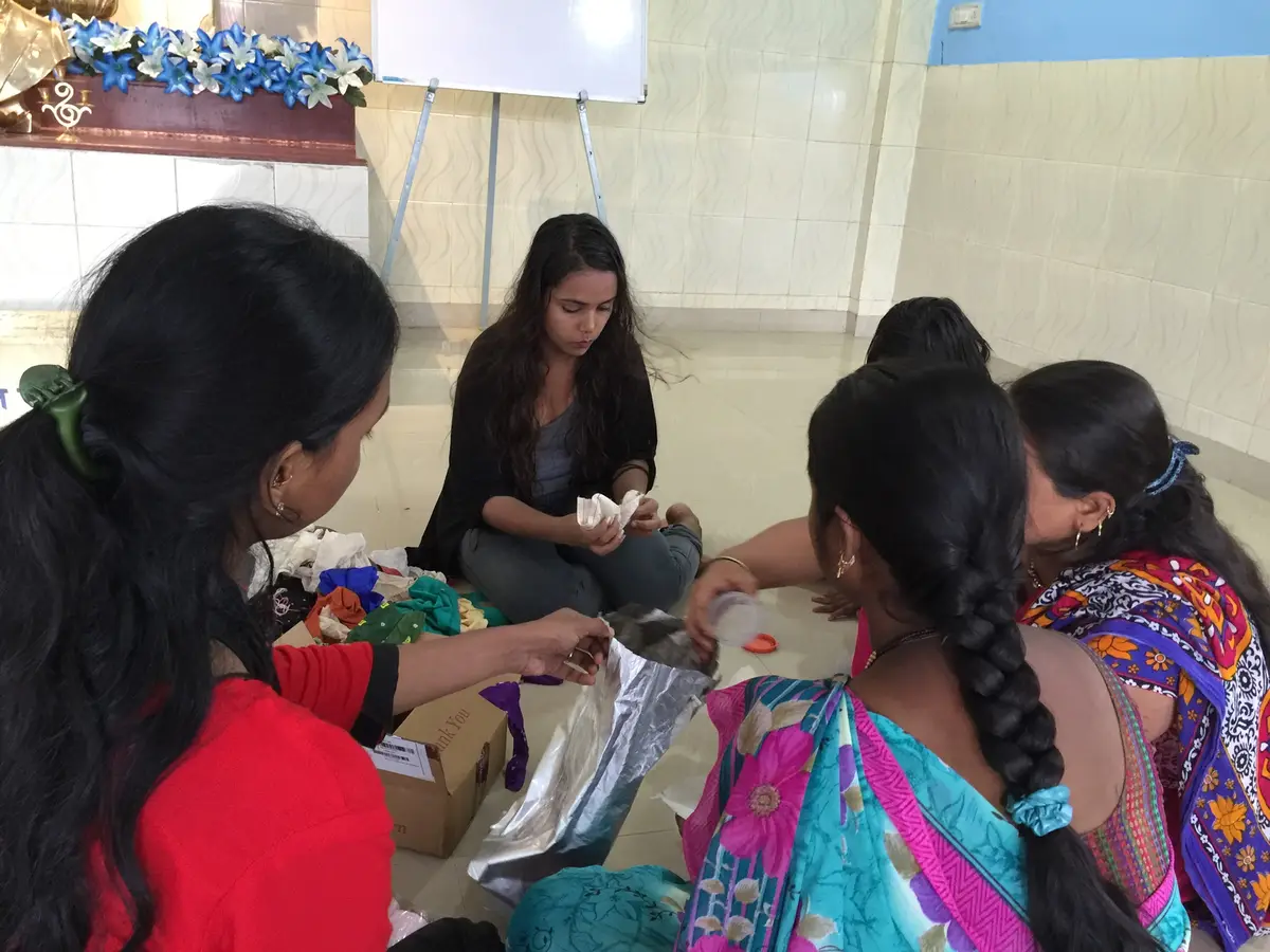 Sustainable fashion internship field work. International volunteers working with local women on a fabric upcycling session, Earth5R CSR programme in Mumbai