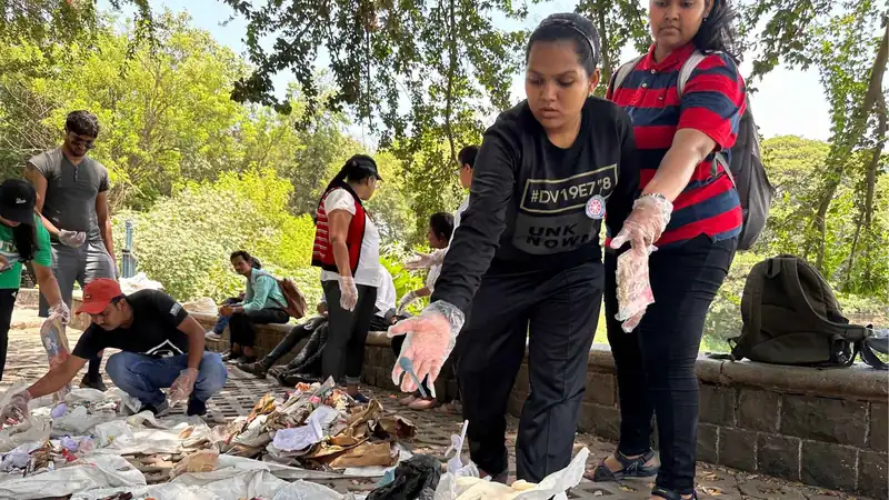 Earth5R volunteers sorting waste collected during a cleanup drive