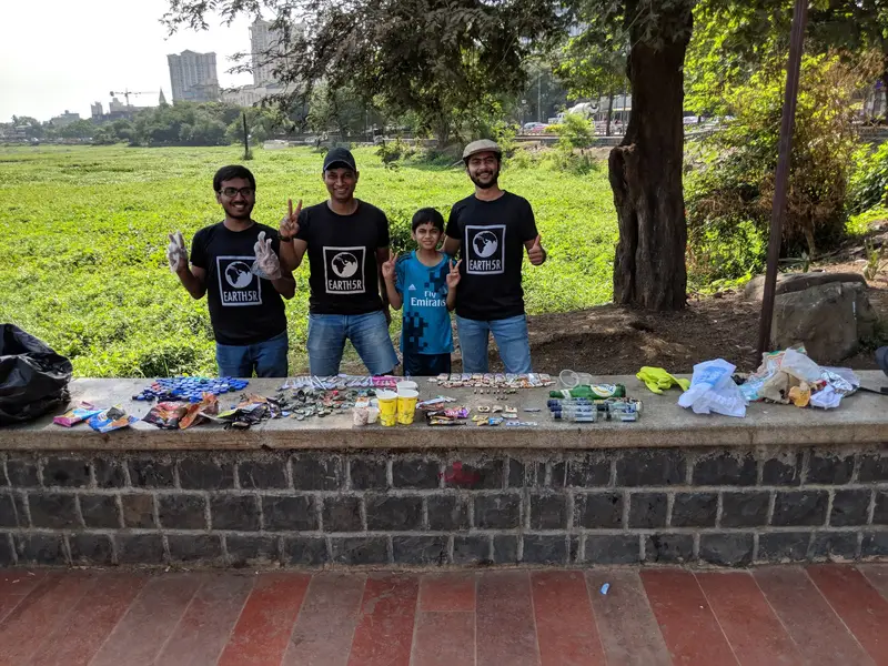 Earth5R volunteers with recovered waste laid out for a waste audit by the lake in Mumbai