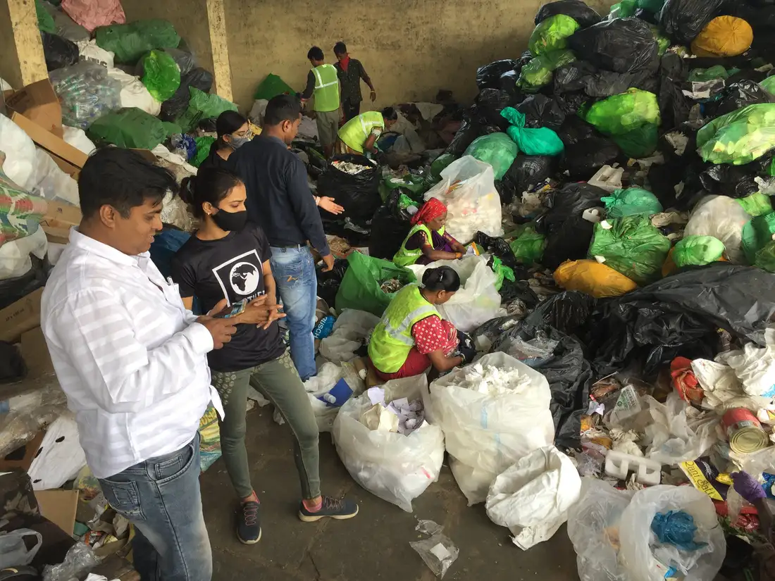 Earth5R team reviewing plastic waste sorting at a material recovery facility in Mumbai