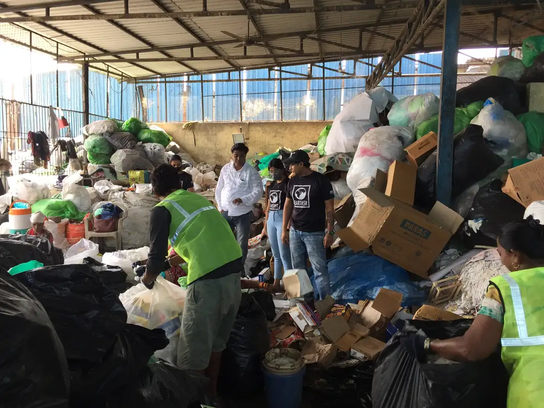 Supply chain internship field work. Waste workers segregating recyclables at a Mumbai material recovery facility visited by the Earth5R team