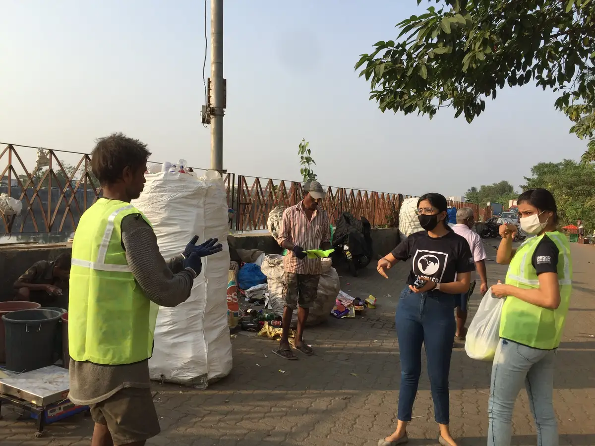 Earth5R trainers with waste collectors and filled sacks along the Mithi riverside path in Mumbai