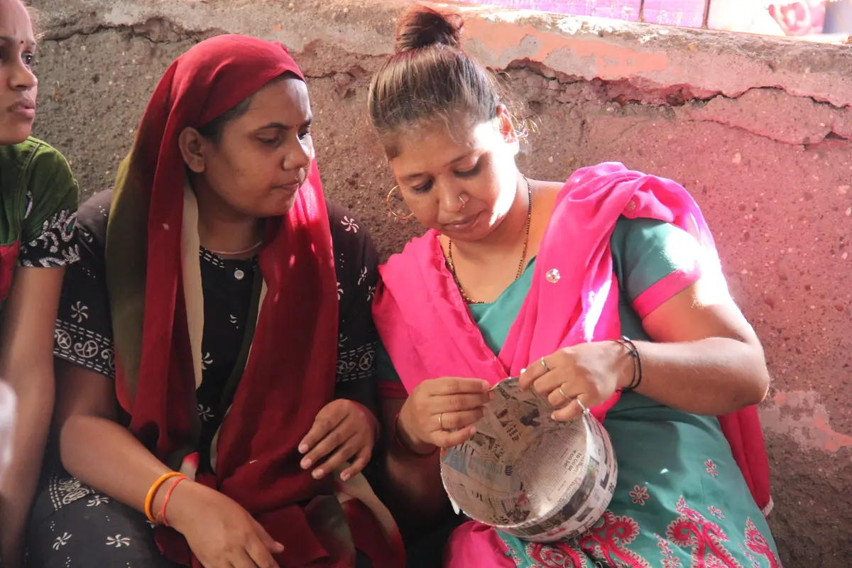 Two women shaping paper mache bowls during an upcycling workshop, Earth5R CSR programme