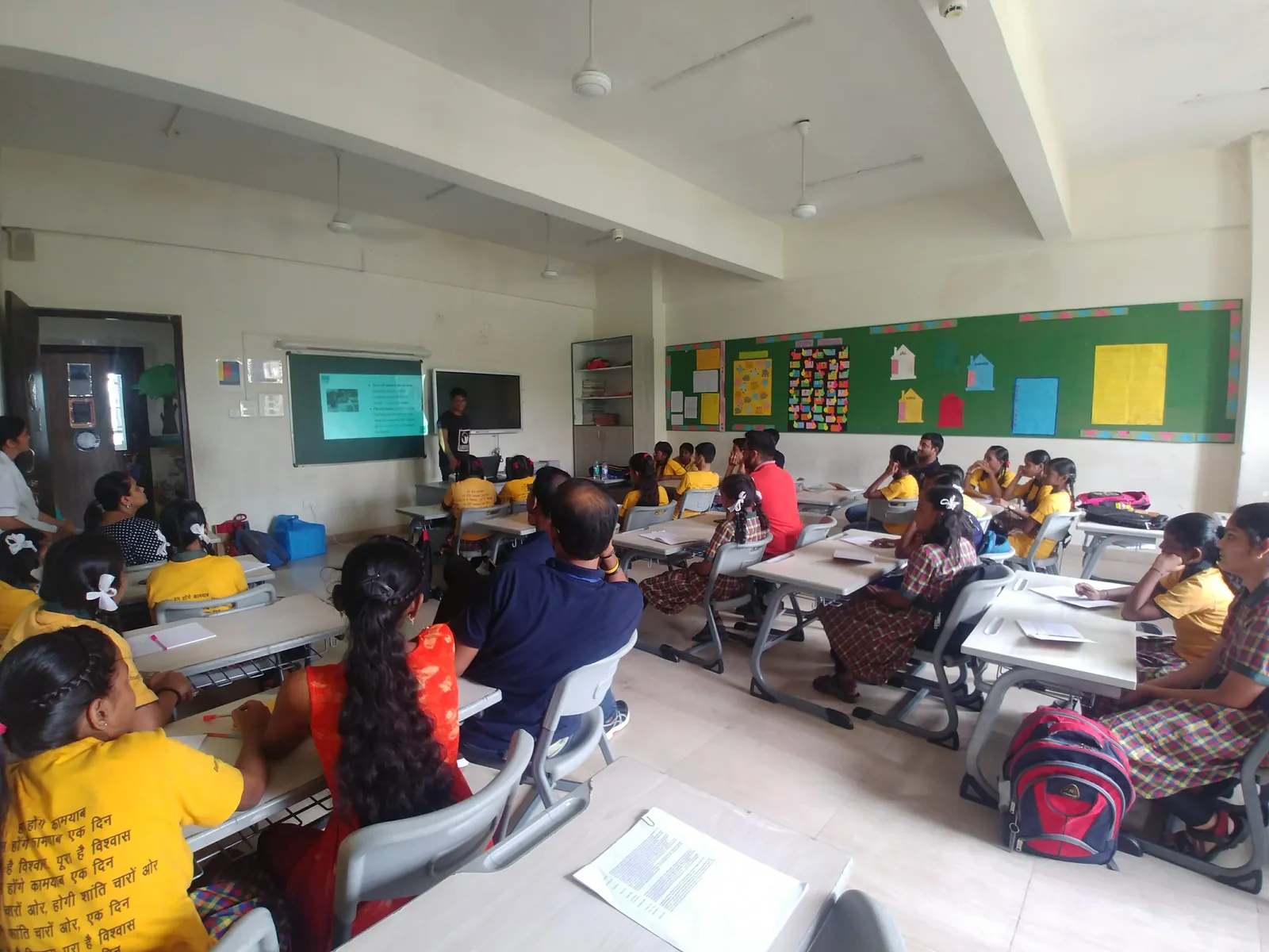 High school computer science internship field work. Students seated at desks during an Earth5R classroom environment activity