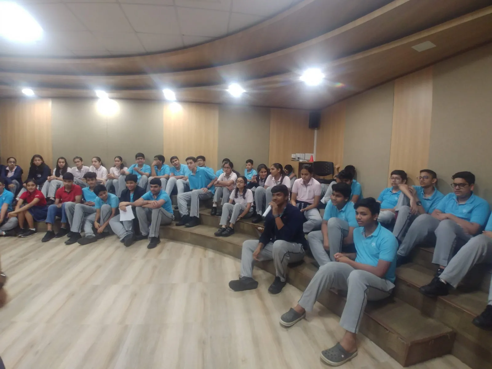 HR internship field work. About 50 corporate volunteers in blue T-shirts seated for an Earth5R briefing