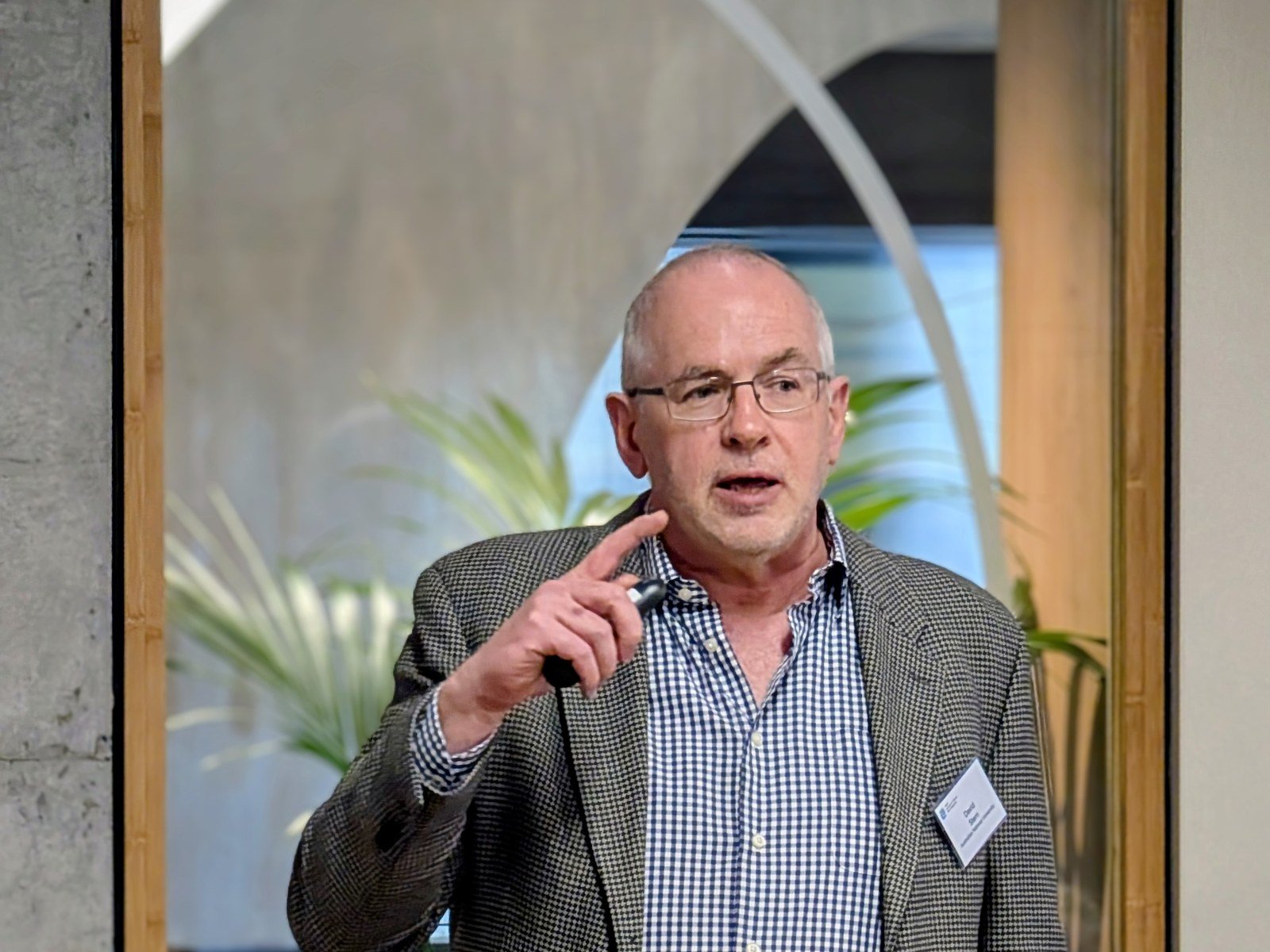Professor David Stern of The Australian National University speaking and gesturing at a climate economics workshop at UNSW Sydney, August 2025
