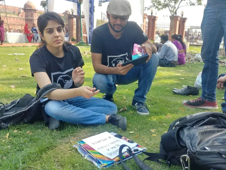 Earth5R volunteers on the grass recording survey notes in a park in Delhi