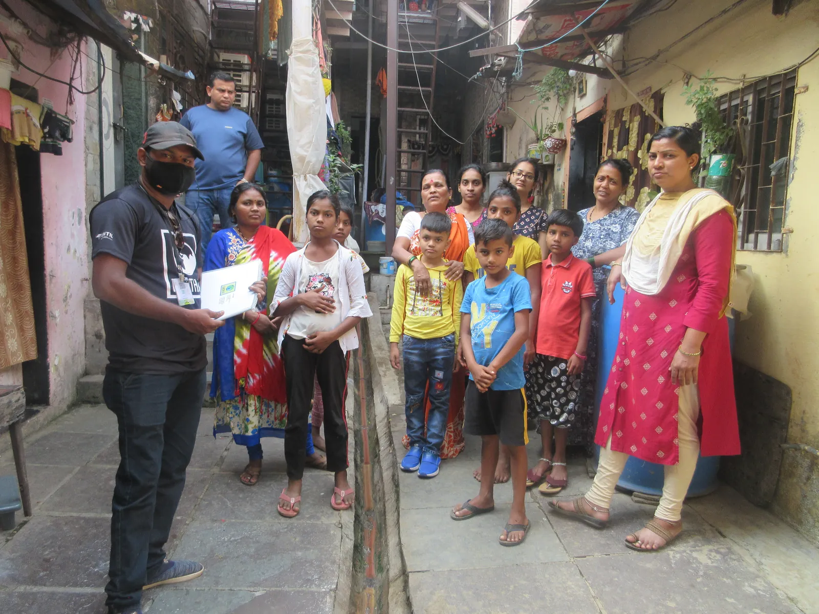 Earth5R volunteers and about 15 residents gathered in a lane for a community meeting
