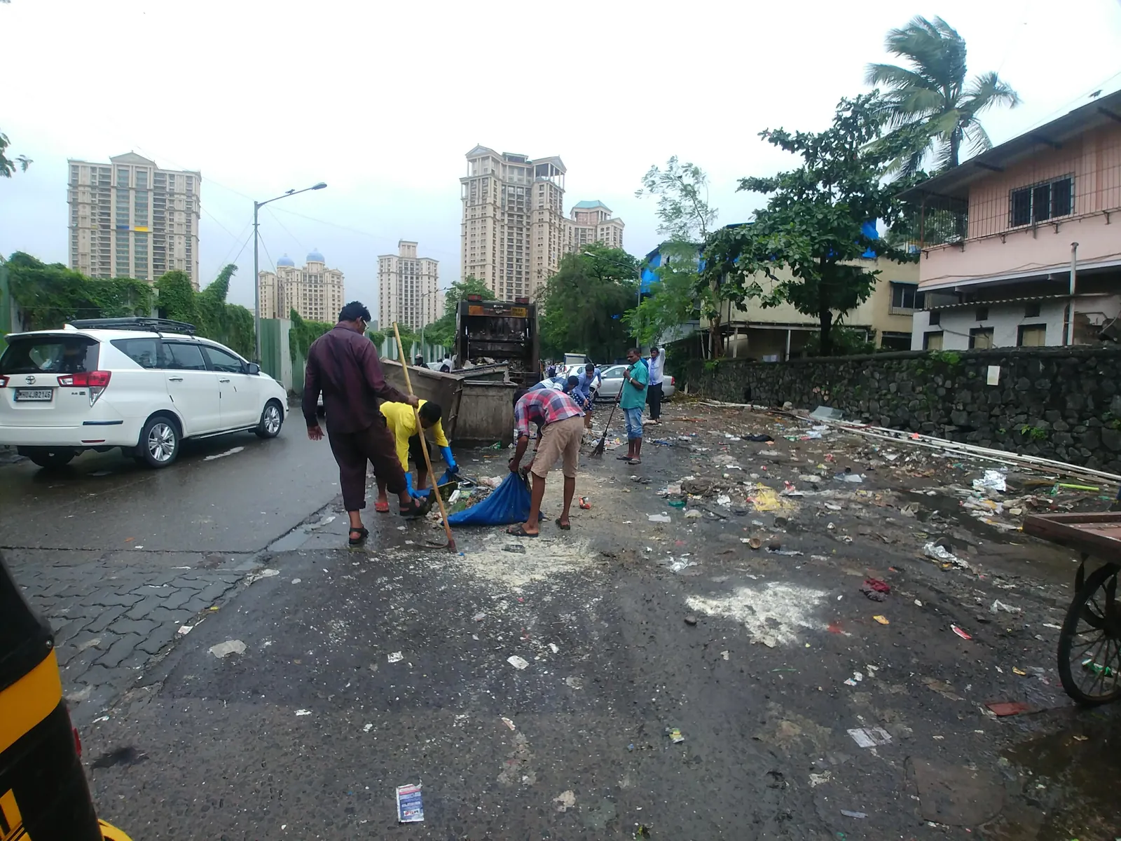 High school civil engineering internship field work. Litter strewn across a road after monsoon rain