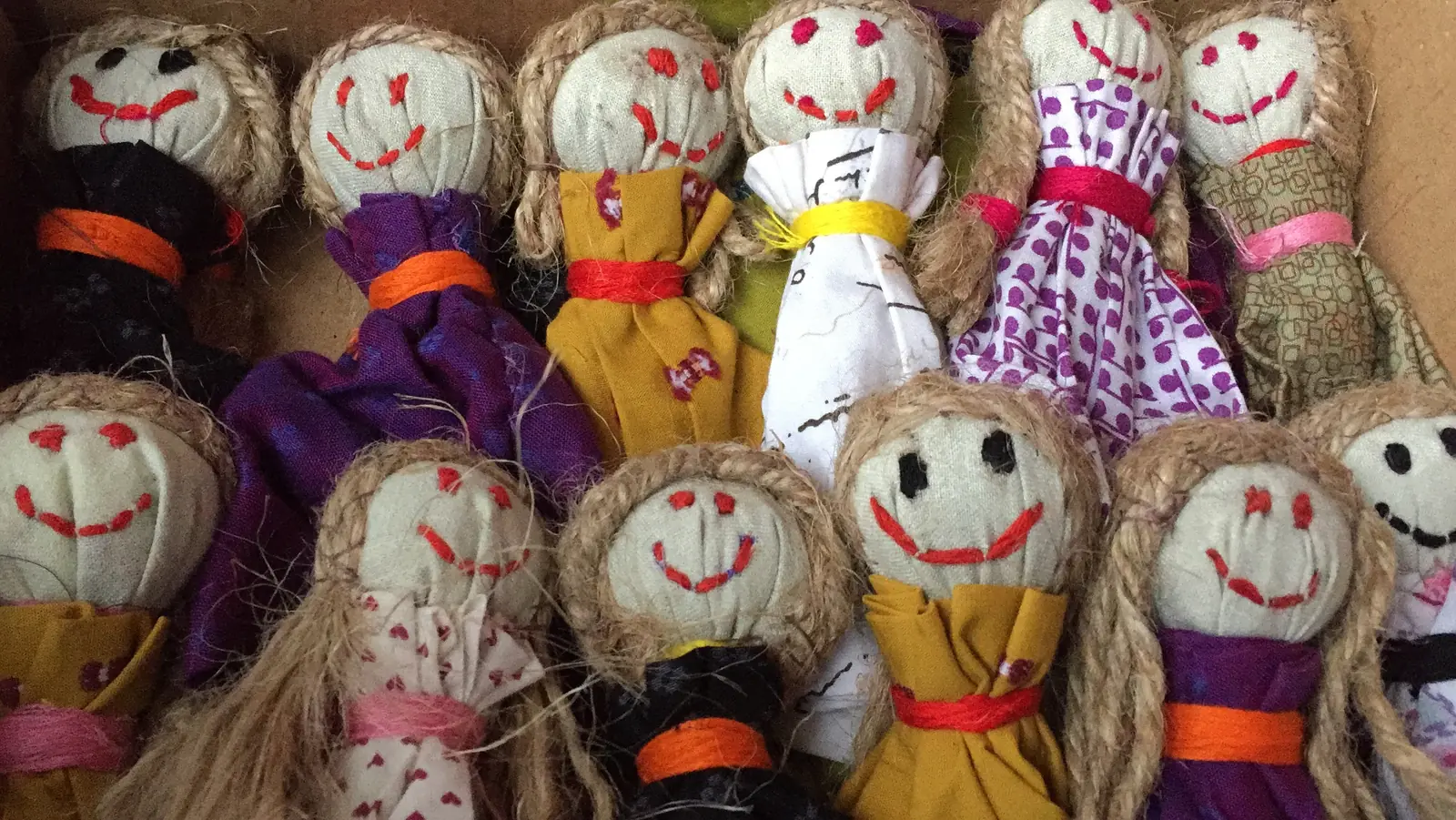 Rows of handmade smiley-face dolls made from cloth scraps by women in a livelihood programme in Powai / Chandivali, Mumbai